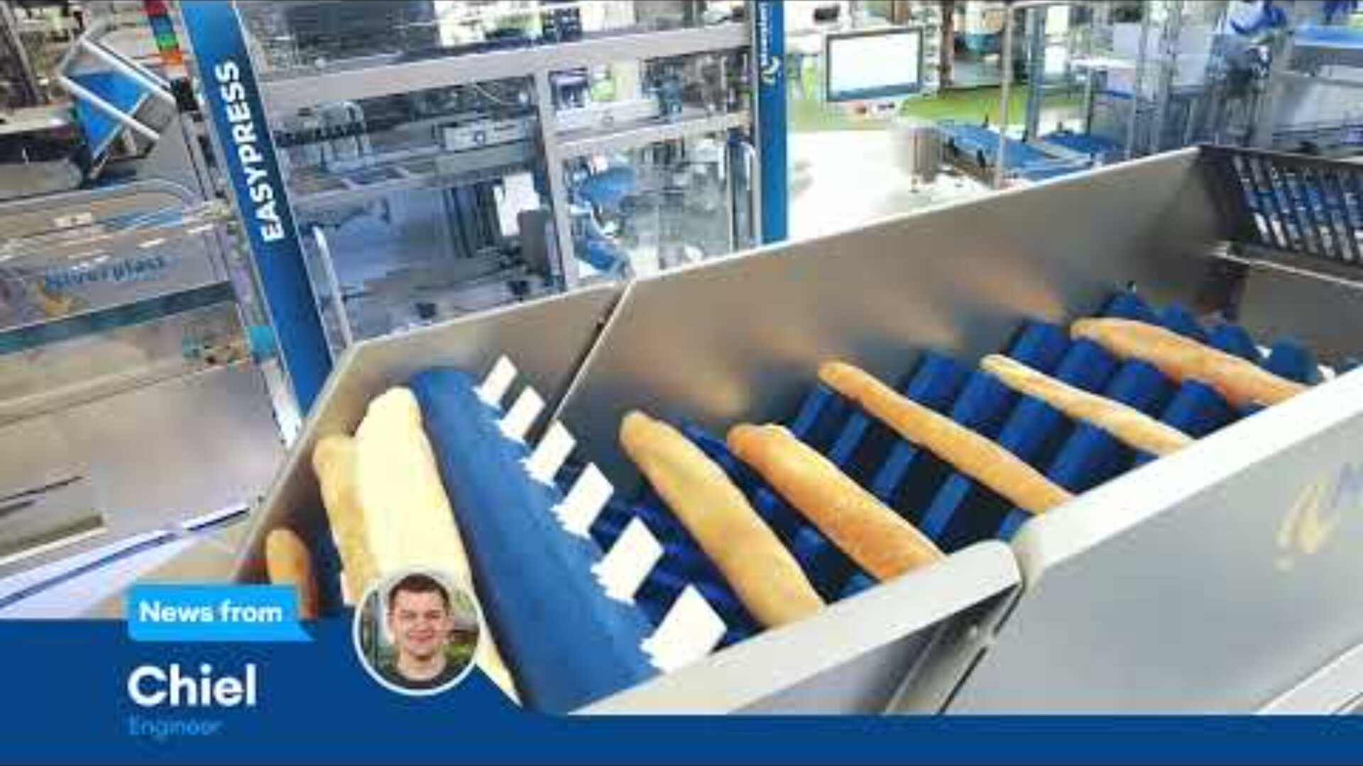 Loaves of bread on a conveyor system inside a factory, with modern baking equipment in the background. A news banner at the bottom shows a photo and text: News from Chiel, Engineer.