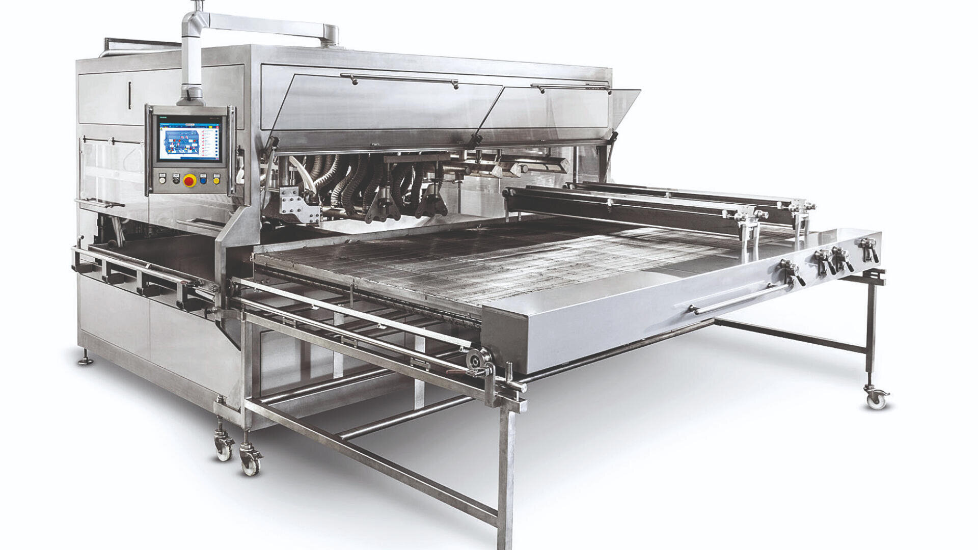 Large industrial stainless steel food processing machine with a control panel, conveyor system, and open work area, designed for automated baking or cooking, set against a white background.