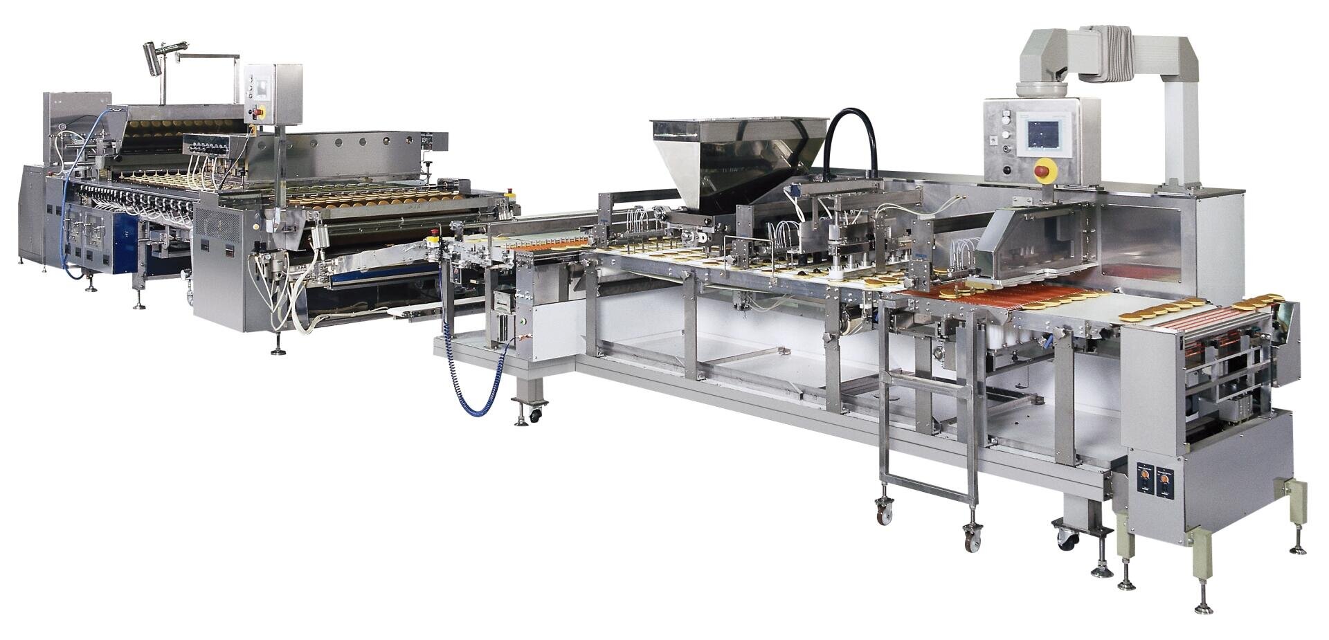 A large, industrial food processing and packaging machine with multiple conveyor belts, metal components, and a control panel, designed for automated production in a factory setting.