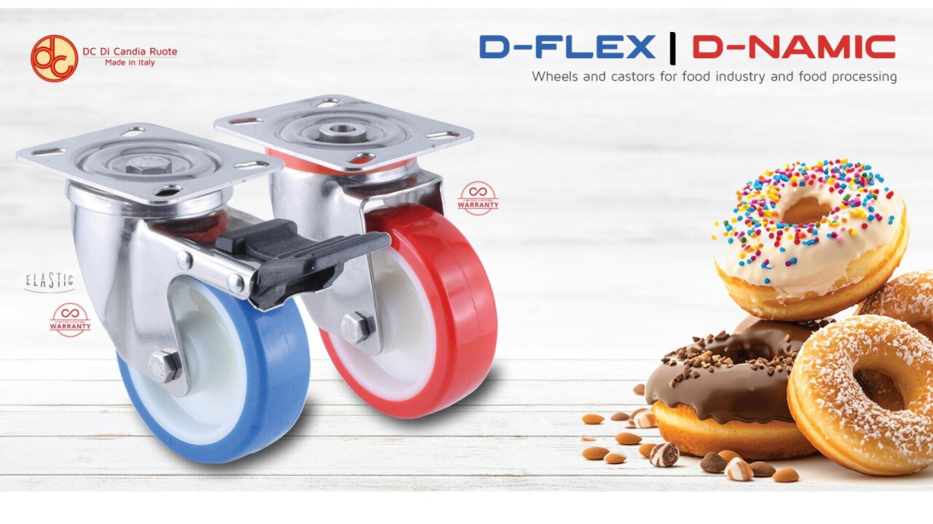 Zwei Industrieräder, eines mit blauem und eines mit rotem Rand, stehen auf einer hellen Holzfläche neben einem Stapel bunter Donuts mit Zuckerguss und Streuseln. Branding und Produktinformationen sind oben abgebildet.