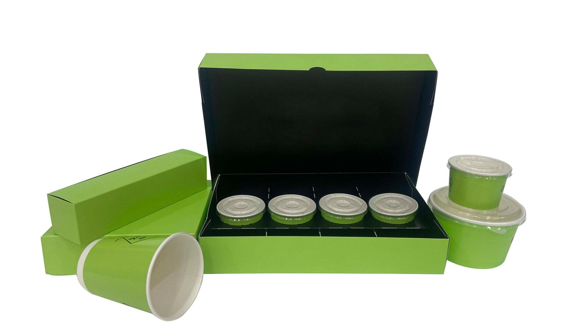 A set of green and white food packaging, including a box with four cups and lids, two rectangular boxes, a stacked container with two cups and lids, and a green paper cup with a white interior, all on a white background.