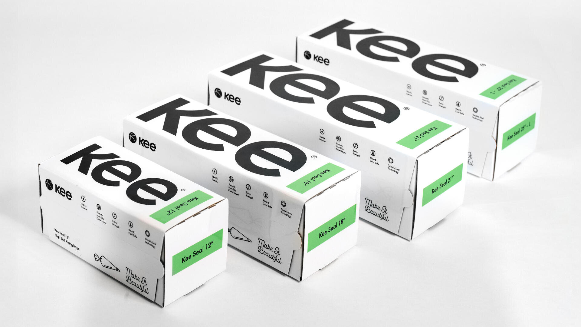 Four white rectangular Kee brand boxes with bold black kee lettering sit in a row. Each box has a green label indicating different sizes: 12, 18, 24, and 36. The packaging appears sleek and minimalist.