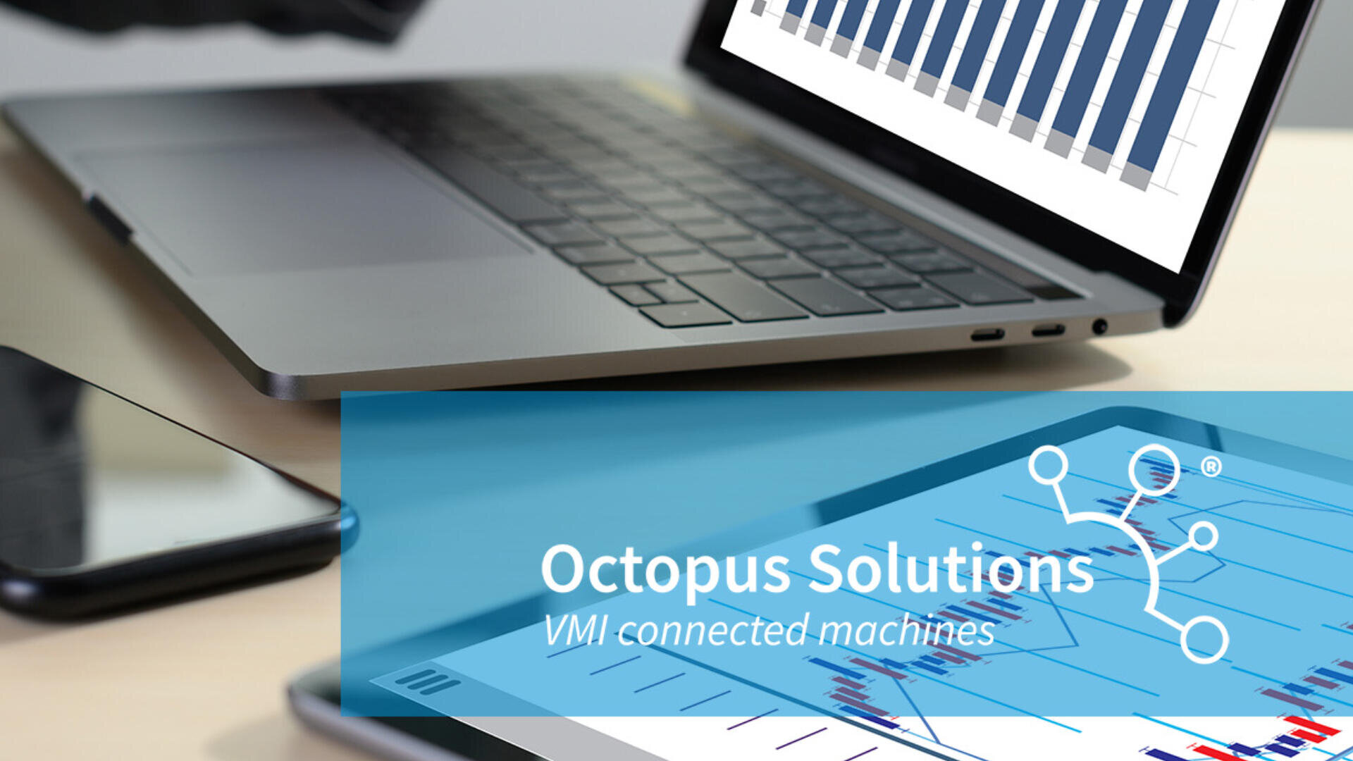 A laptop displaying a bar graph is on a desk next to a smartphone. In the foreground, a blue overlay shows the Octopus Solutions logo with the text “VMI connected machines” and a partial view of a tablet with charts.