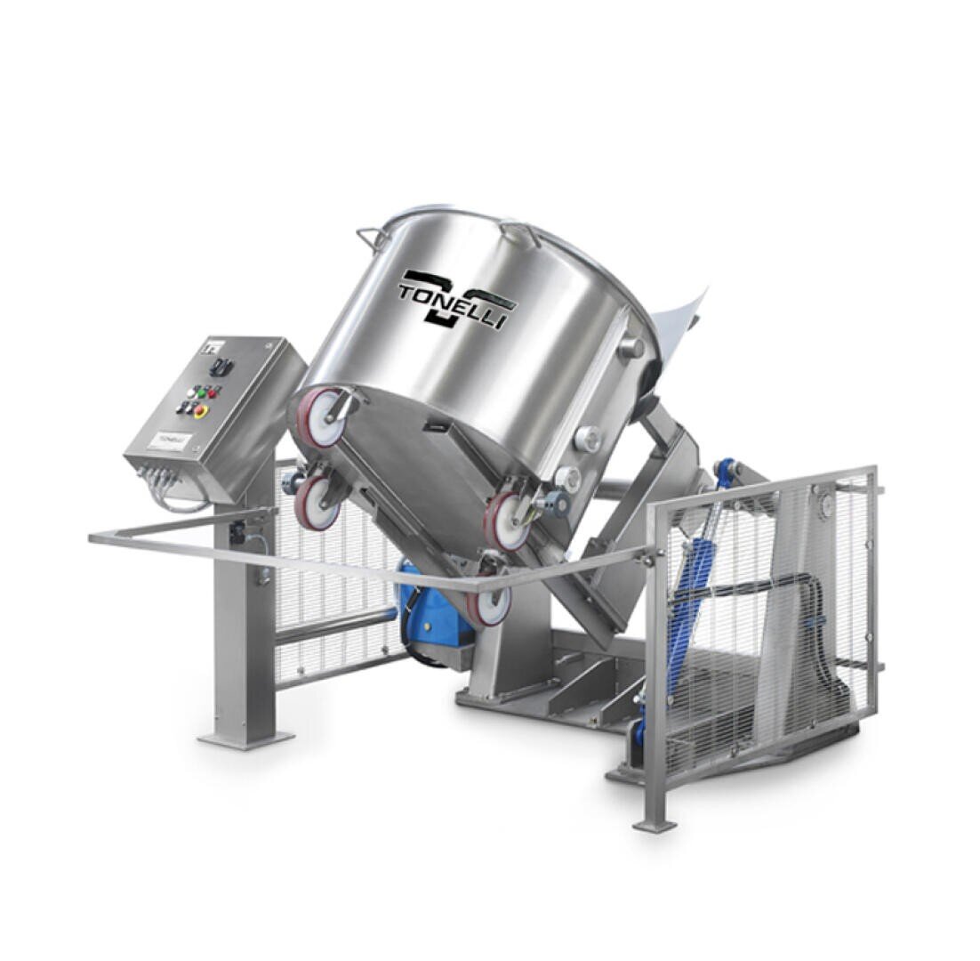 A large industrial stainless steel mixer with a tilted mixing bowl, control panel, and safety barriers, branded with the Tonelli logo.