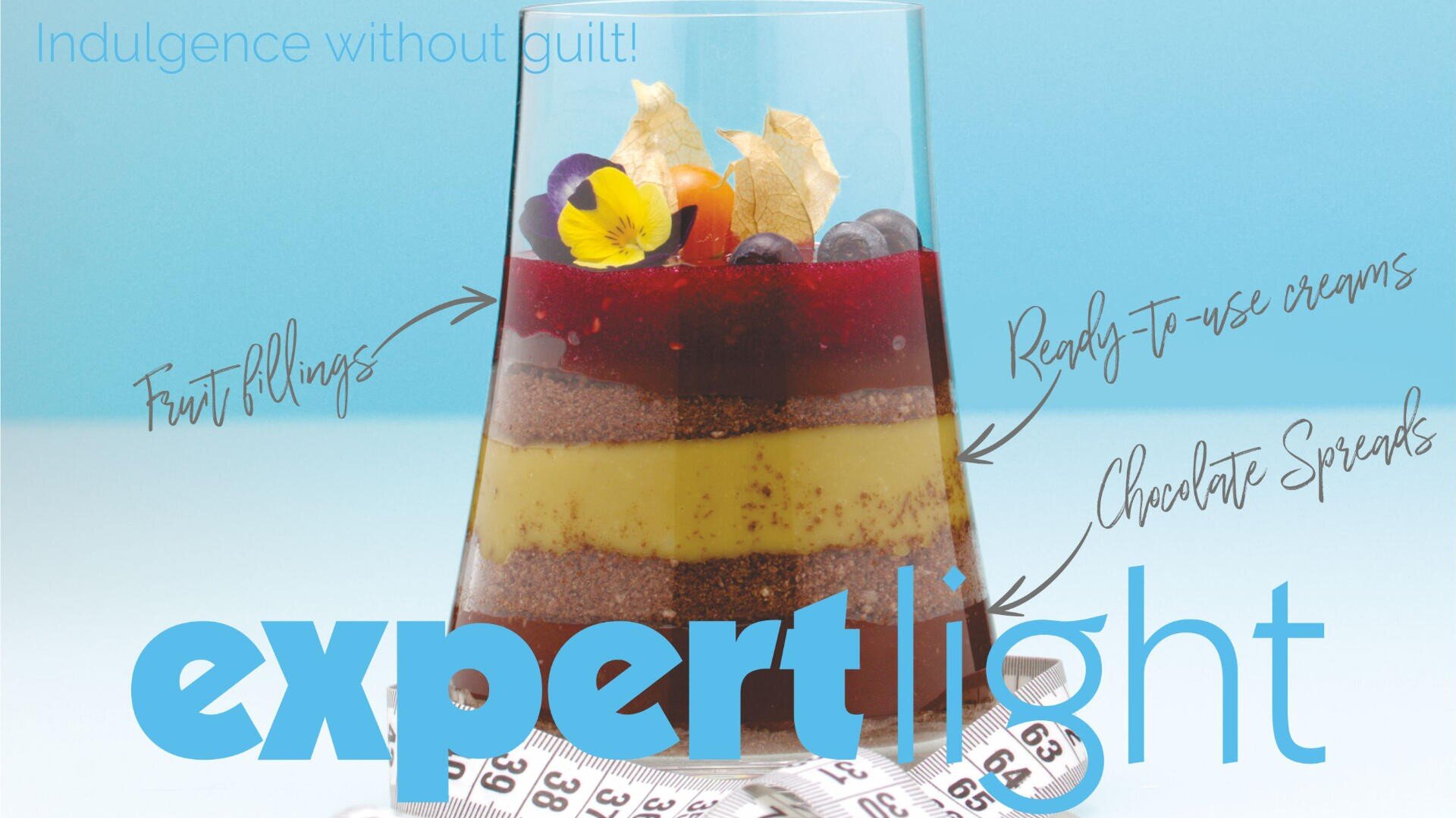 A layered dessert in a glass with fruit, cream, and chocolate, topped with berries and a flower. Arrows label the layers: “Fruit Fillings,” “Ready-to-use creams,” and “Chocolate Spreads.” A measuring tape is in the foreground.