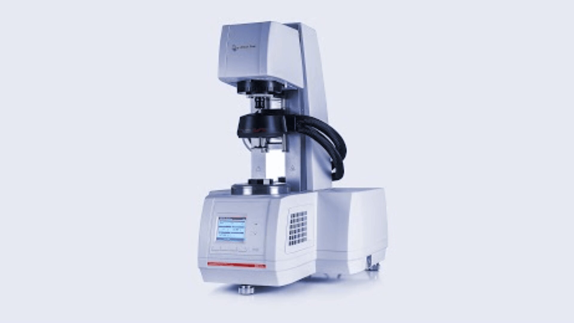 A modern laboratory rheometer with digital display and control panel, equipped with a top-mounted measuring head and a cylindrical sample holder, used to measure material viscosity and flow properties.