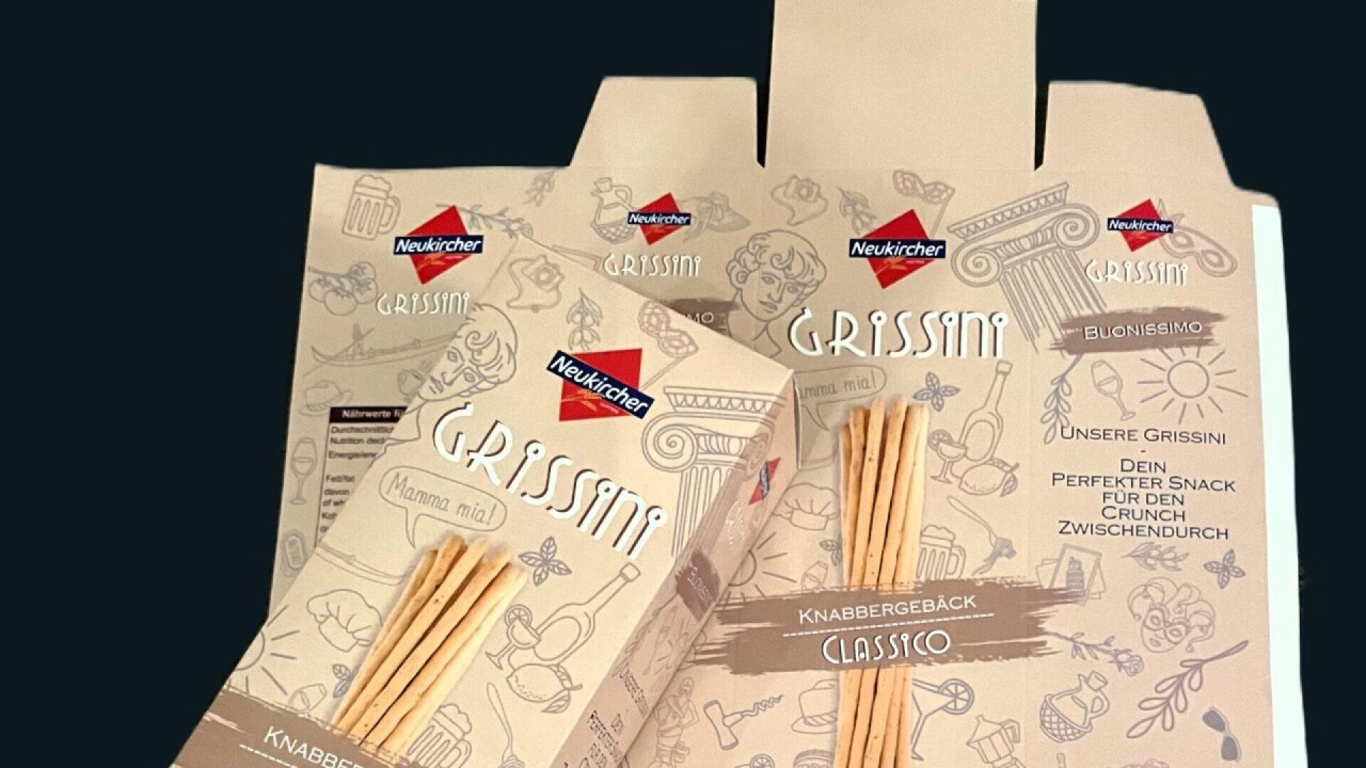 Several beige packages of Neukircher Grissini breadsticks are displayed against a dark background. The boxes feature illustrations of breadsticks and icons, with red and white Neukircher branding at the top.