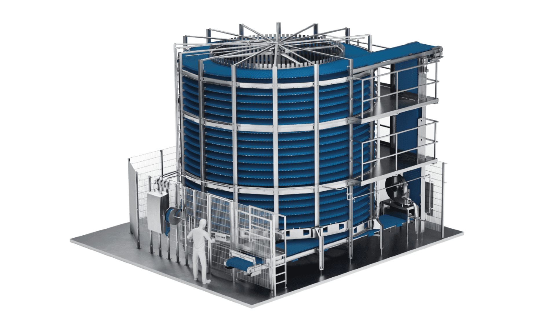 A large industrial spiral freezer with blue conveyor belts loops vertically around a central column; a person stands nearby for scale, highlighting the machines size and structure.