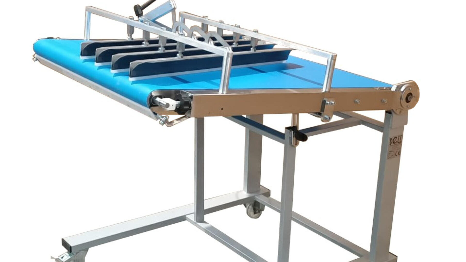 A blue and silver industrial conveyor machine with adjustable metal guides and rollers, mounted on a wheeled metal frame for mobility.