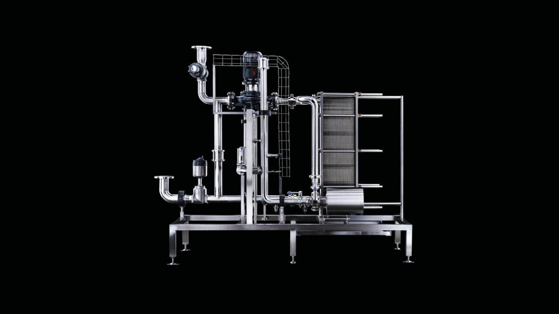 A stainless steel industrial filtration or processing machine with multiple vertical and horizontal pipes, valves, and a plate heat exchanger, set against a solid black background.