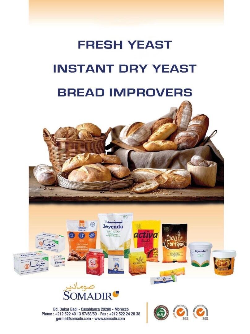 A display of various breads in baskets with text reading Fresh Yeast, Instant Dry Yeast, Bread Improvers. Assorted SOMADIR yeast and bread improver products are shown below with contact information.