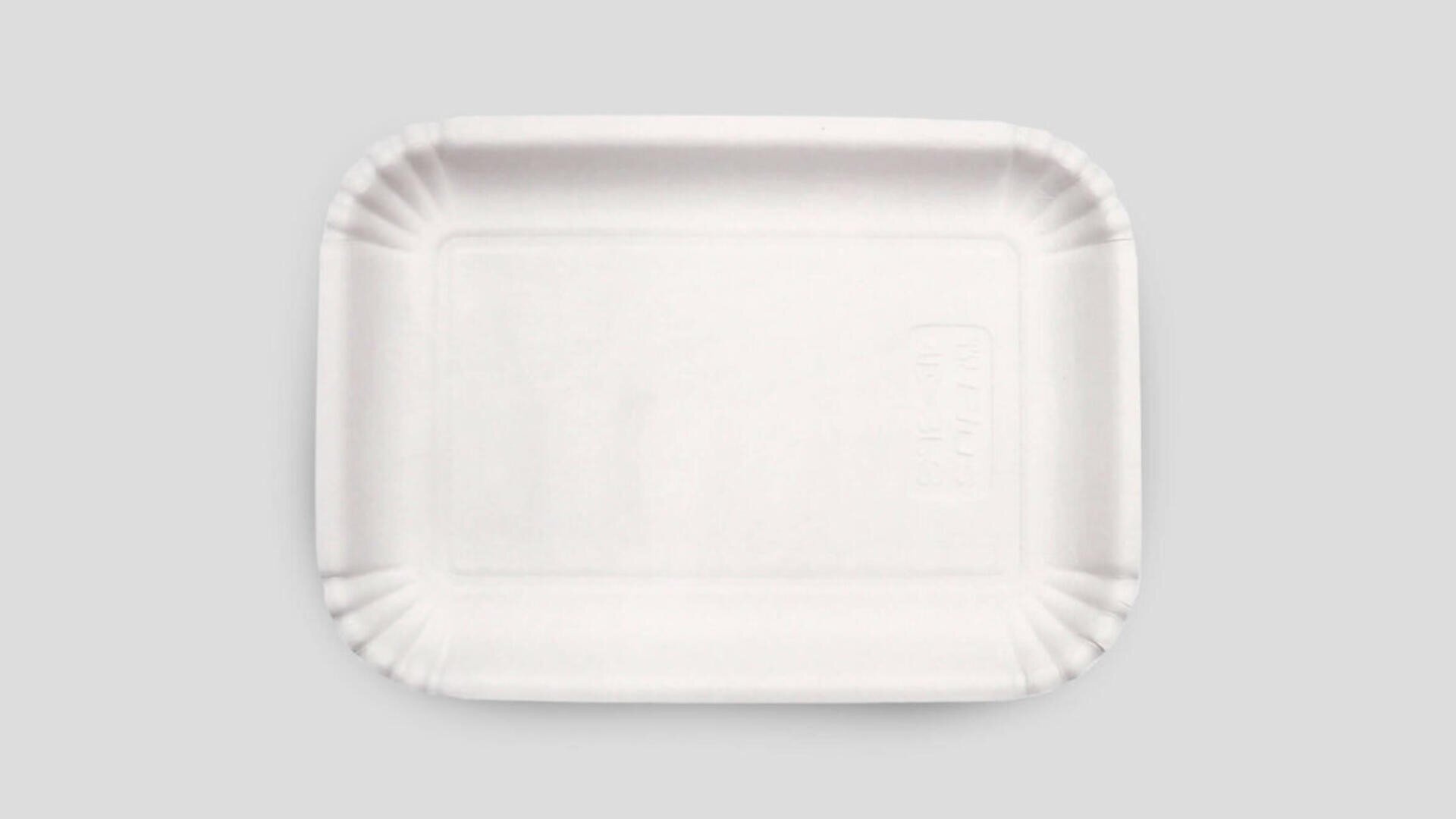 A plain, rectangular white paper tray with slightly raised, ridged edges, placed on a light gray background.