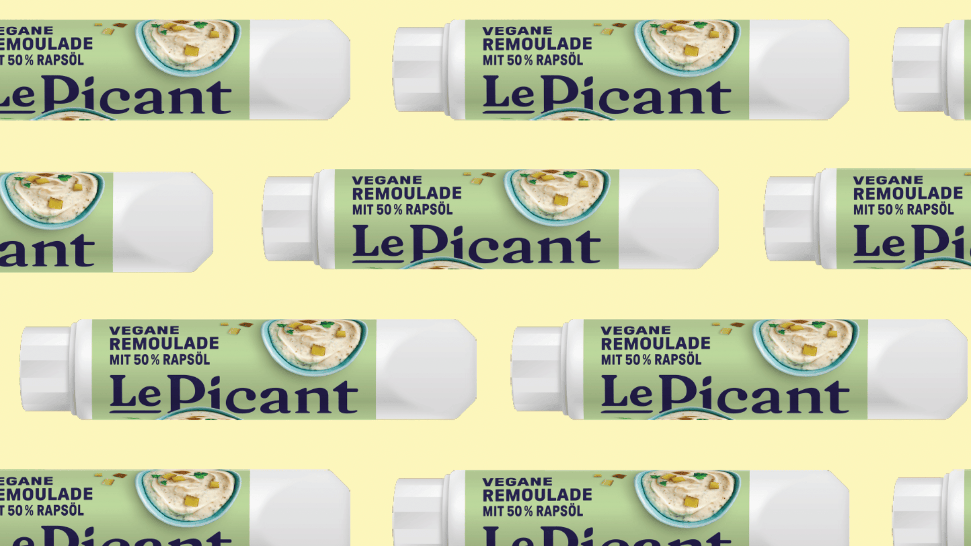 Die Tuben der veganen Remoulade Le Picant mit 50 % Rapsöl sind in einem sich wiederholenden Muster auf hellgelbem Hintergrund angeordnet. Auf der Verpackung sind Remoulade und Salat abgebildet.