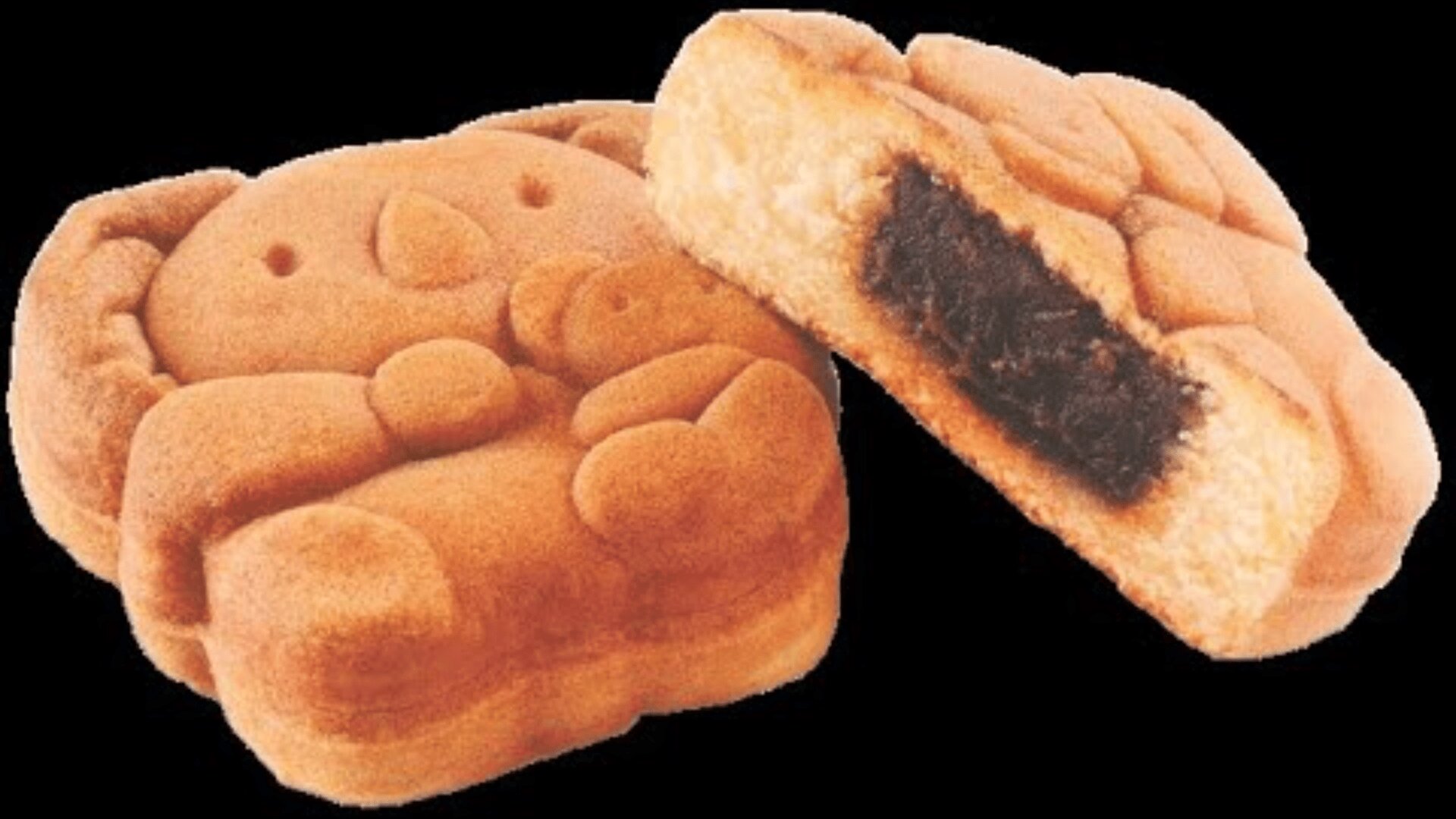 A baked pastry shaped like a cartoon koala, with one piece cut open to show a dark sweet filling inside.