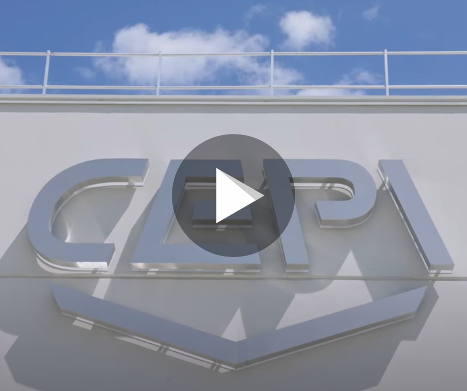 A large metallic CEPI logo on a white building facade, with a bright blue sky with scattered clouds in the background. A play button overlay is visible in the center of the image.