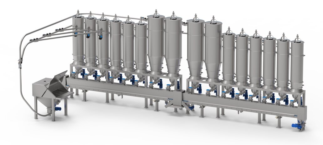 A stainless steel industrial processing system with multiple tall, cylindrical tanks connected by pipes and valves, mounted on a metal frame, likely used for handling liquids or powders in food or pharmaceutical production.